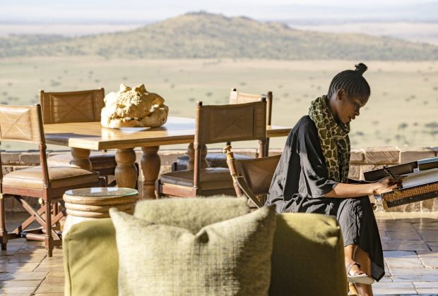 Singita+Sasakwa+Lodge_Guest+on+Verandah